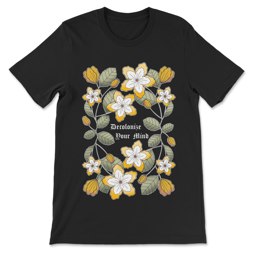 A black tee featuring a floral plattern with a decolonized minds wordmark