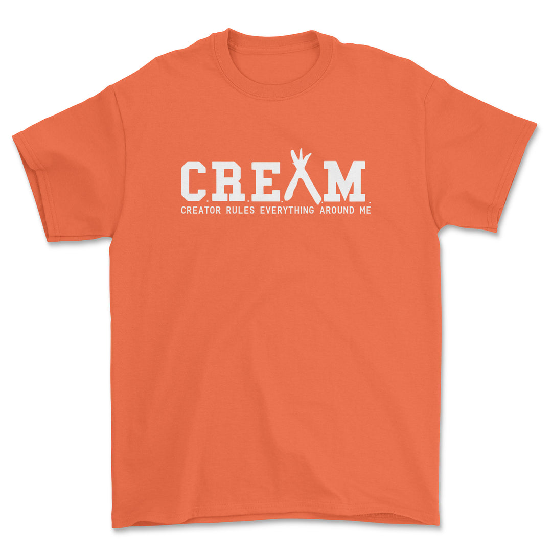 Orange t-shirt with white text 'CREAM' on a white background